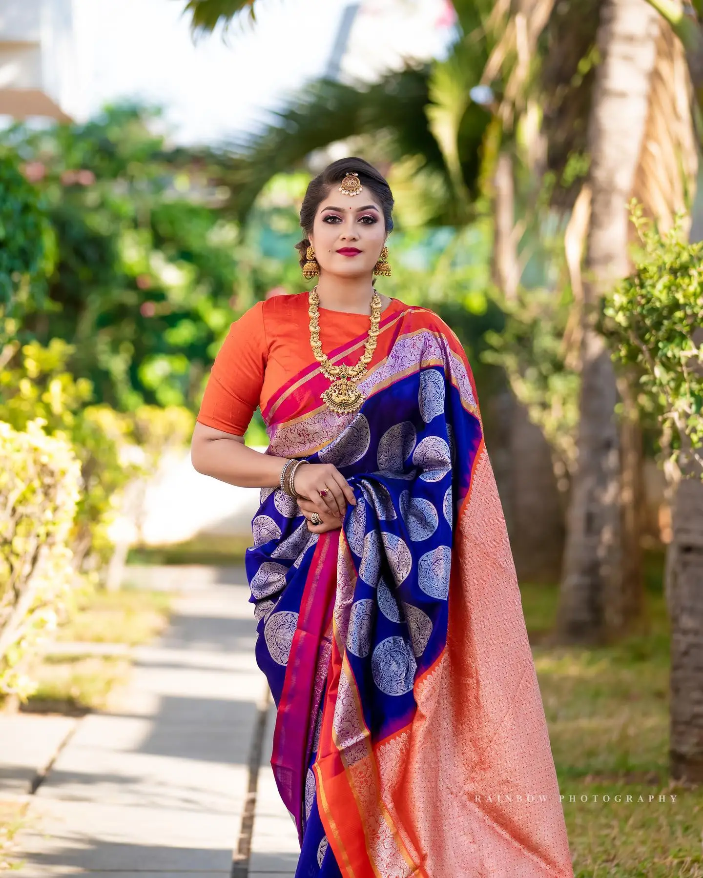 Meghana Raj Wearing Beautiful Earring Jewellery Blue Saree Orange Blouse